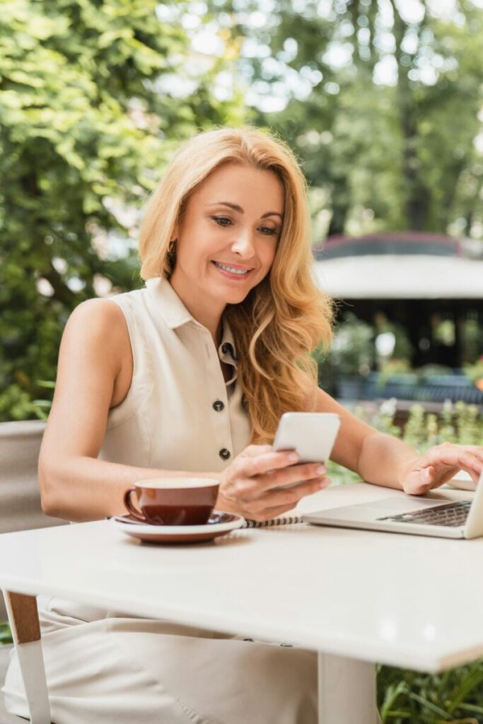 Vertical photo of successful mature businesswoman working remotely on distance on laptop